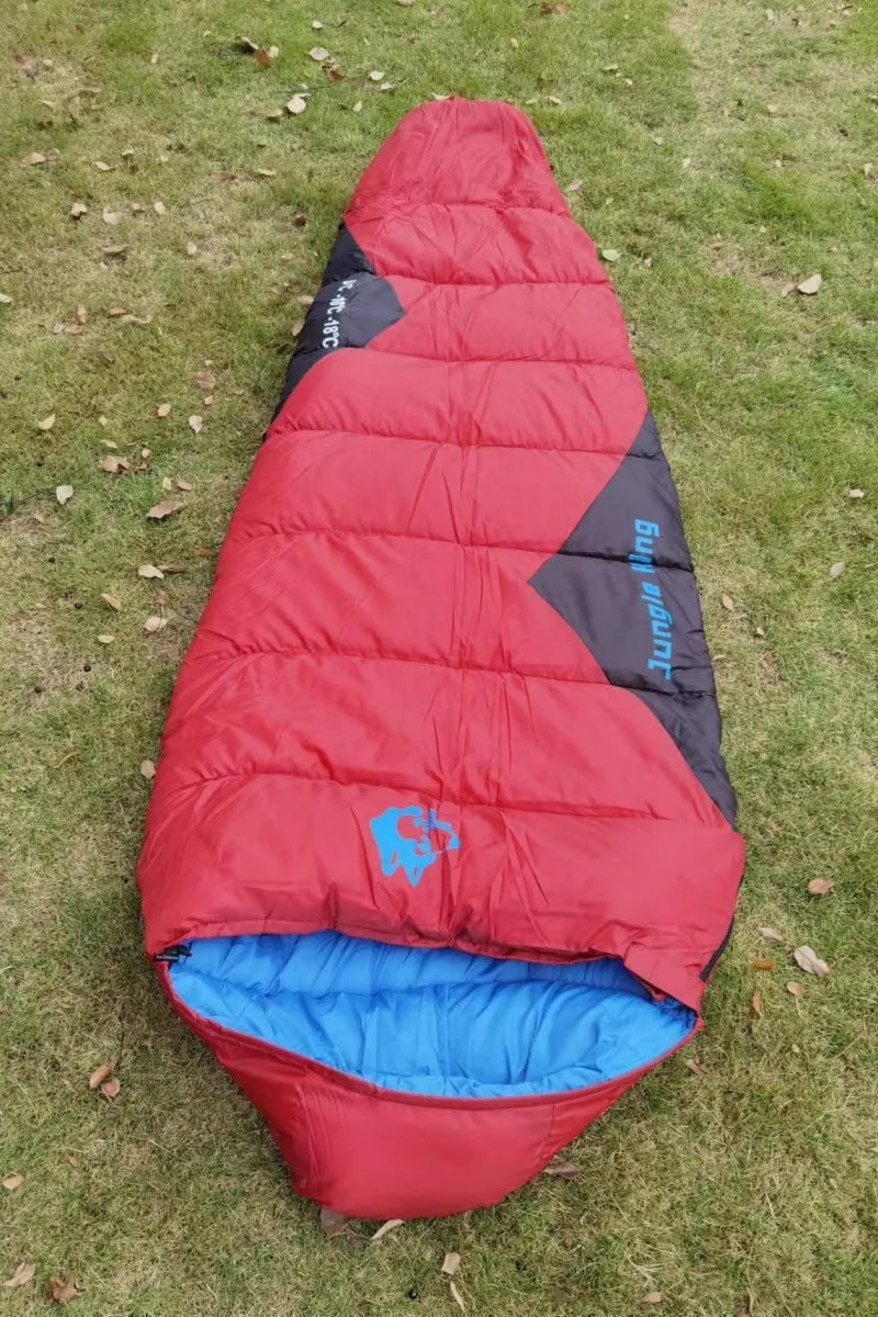 Mummy style camping sleeping bag in a colour option, shown next to its compression sack.
