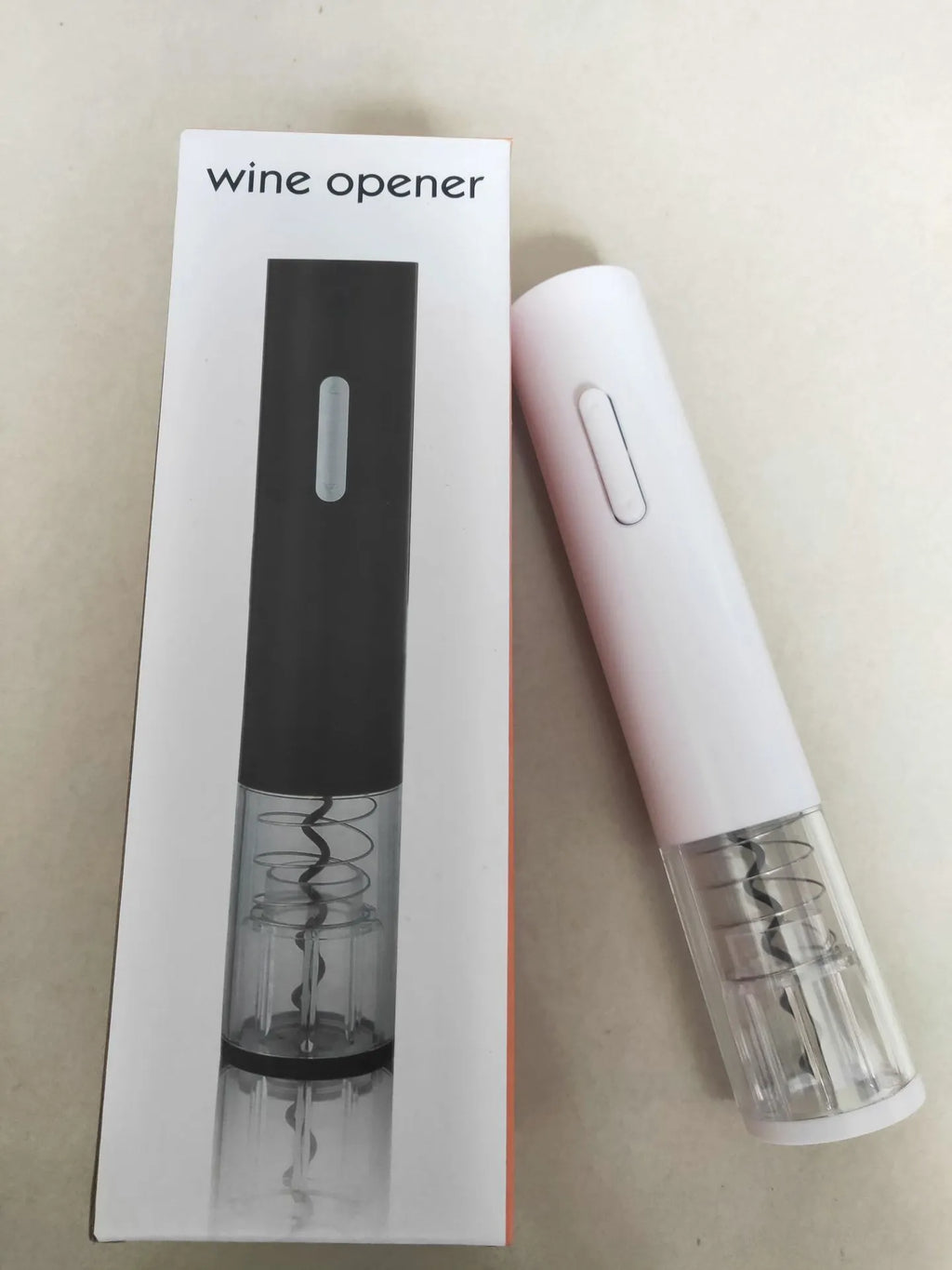 Black automatic electric wine bottle opener with foil cutter on a kitchen counter