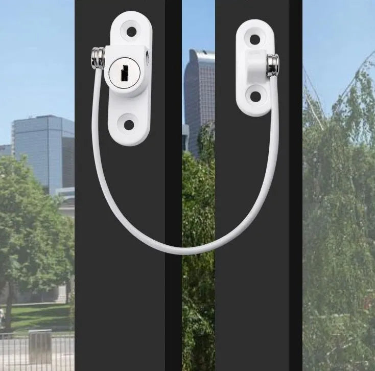 White window security chain lock with steel cable and adhesive base on a window frame