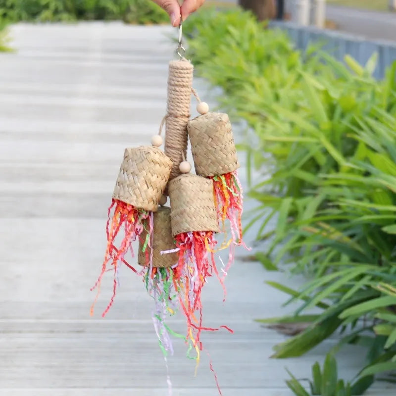 Colourful shredded paper and wood parrot hanging toy with sisal rope for medium birds.