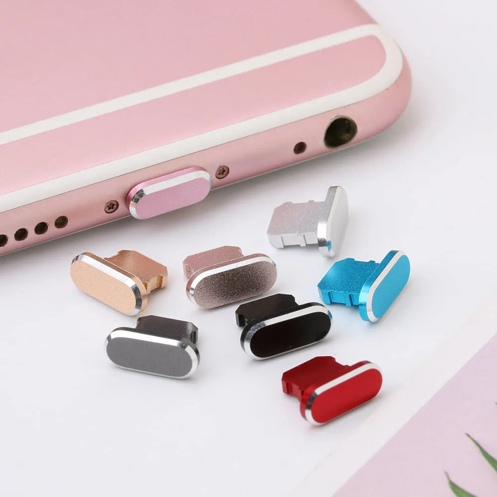 Aluminium alloy iPhone charging port dust plug in metallic colours on a dark background.