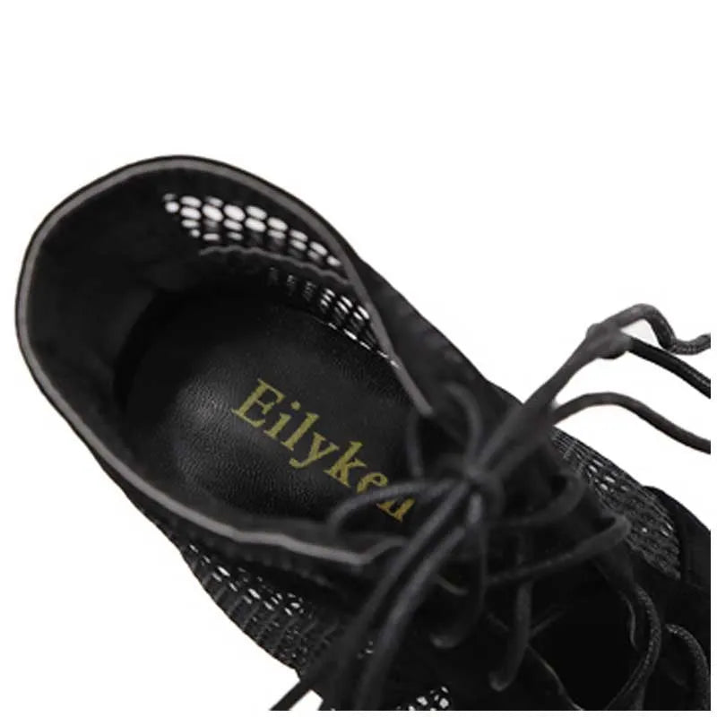 Black suede women's lace-up high heel shoes with 11.5cm heel shown from side view