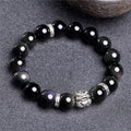 Natural obsidian and Silver 999 Cloud Year bracelet in simple unisex style on wrist.
