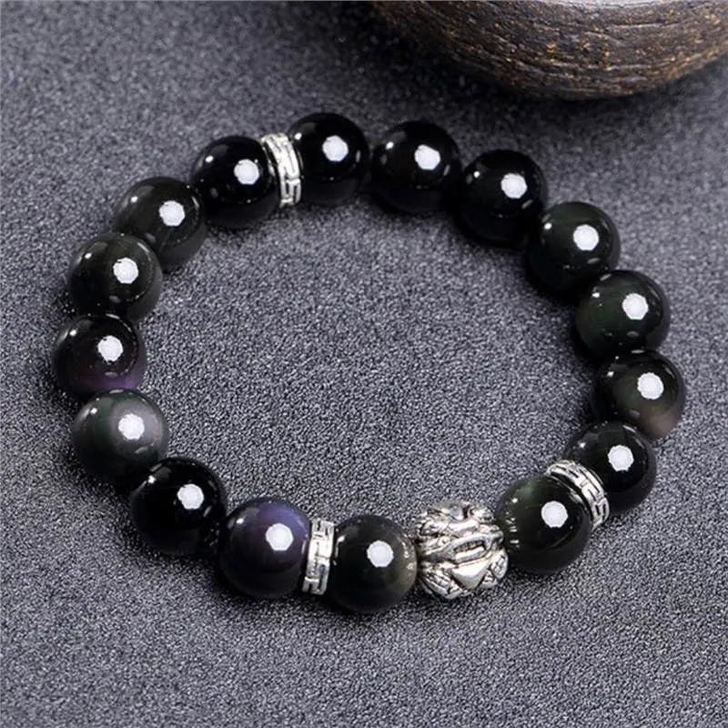 Natural obsidian and Silver 999 Cloud Year bracelet in simple unisex style on wrist.
