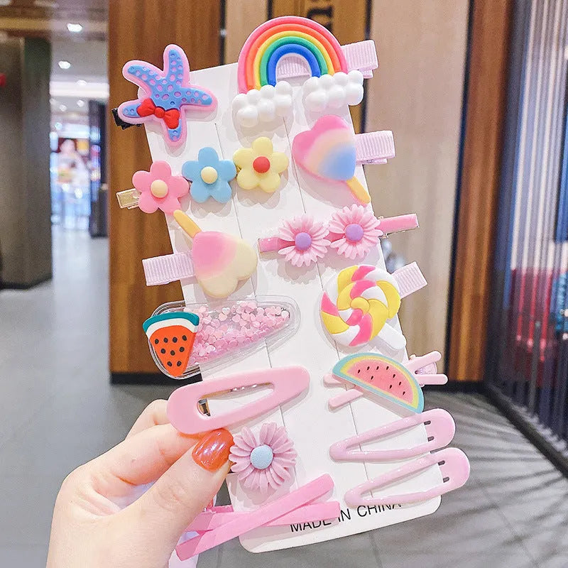 14-piece set of colourful toddler hair clips with candy, fruit, rainbow, and butterfly designs on a white background.