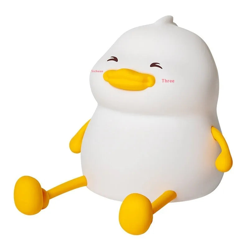 Chubby Night Light silicone desk lamp and mobile phone holder on a wooden surface.