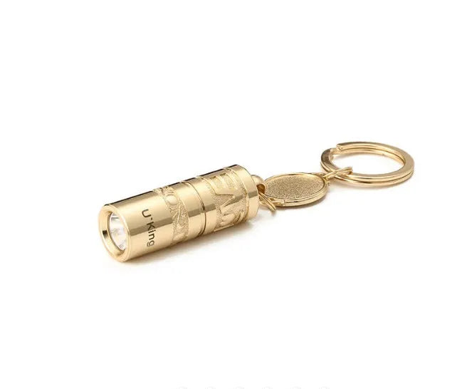 Gold zinc alloy waterproof LED keychain flashlight on a keyring.