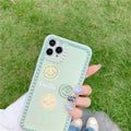 Green geometric pattern iPhone case with smiley faces and polka dot frames on a phone