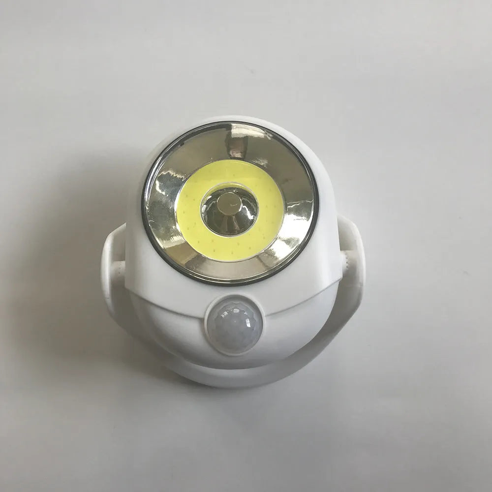 Atomic Angel white induction light with ABS plastic housing measuring 13.3 by 9.8 by 15.8 centimetres
