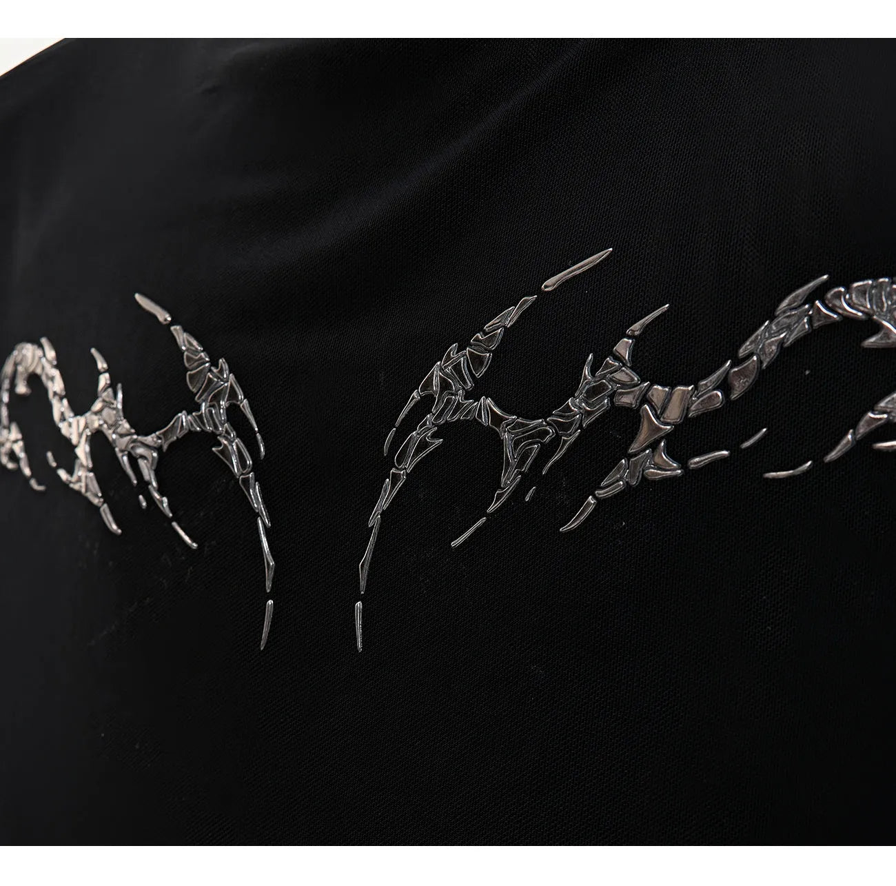 Man wearing a black niche mesh slim-fit long sleeve shirt showing texture and fit.