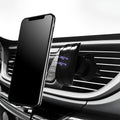 Black car phone holder mounted on car air vent with adjustable clamp and flexible positioning arm