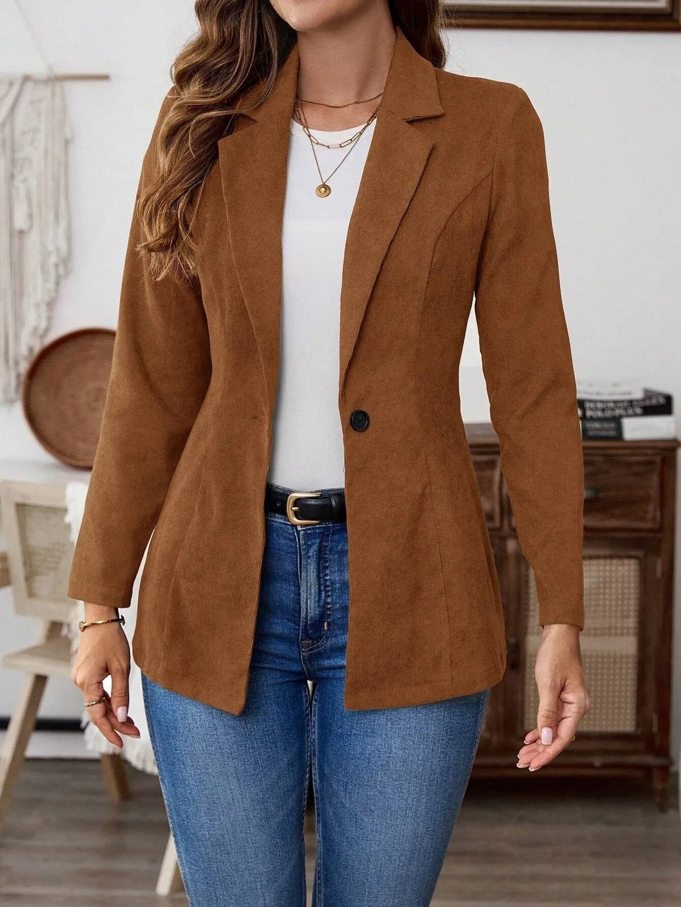 Brown men's single-breasted lapel coat with long sleeves on a hanger