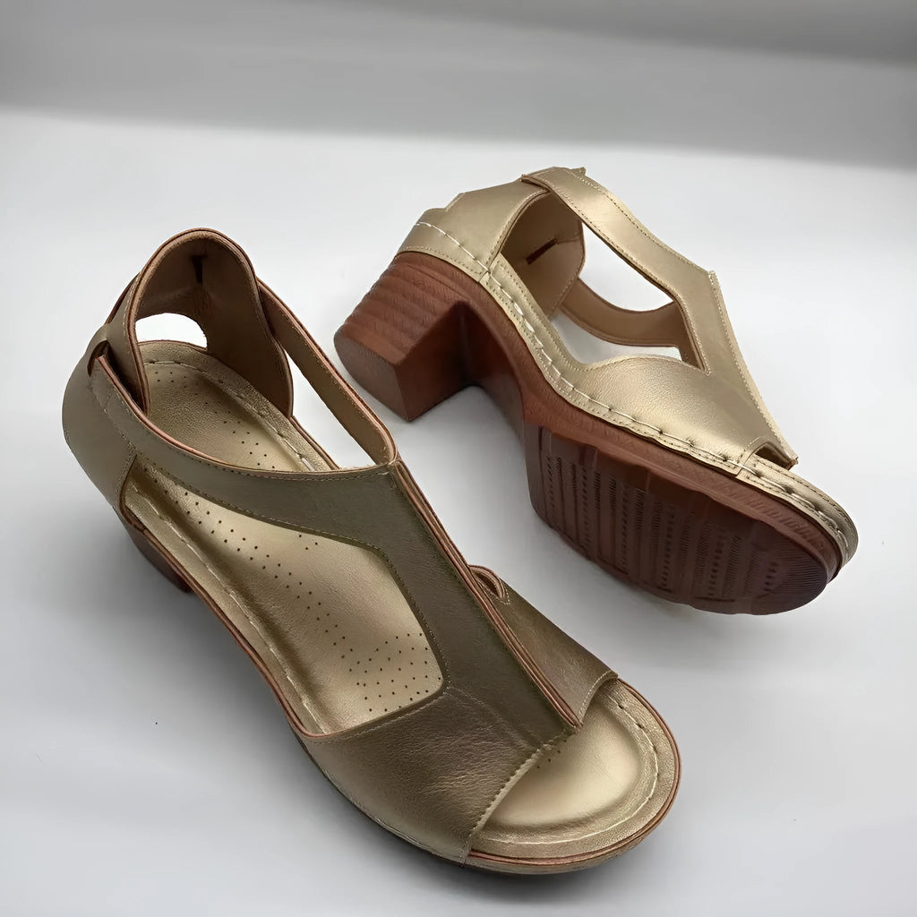 Women's plus size beige peep toe wedge sandals with a buckle strap and low heel.
