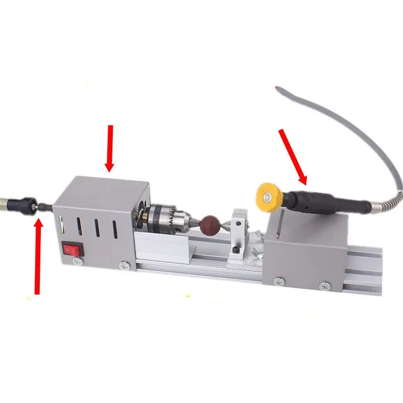 Silver metal mini woodworking lathe with carving tools on workbench