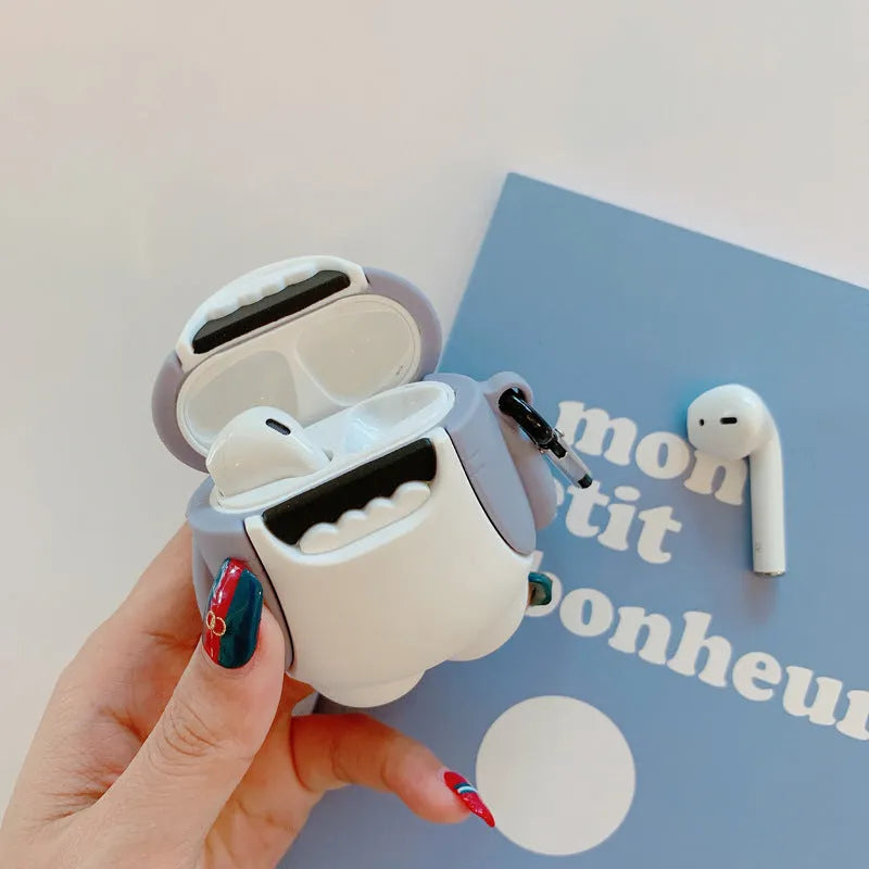 Soft silicone cover with shark fin design on a white Apple Airpods 1 wireless earbud.