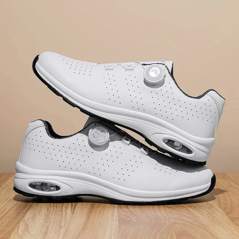 Black and white low top mesh casual shoes with cross shoulder straps and lace-up front.