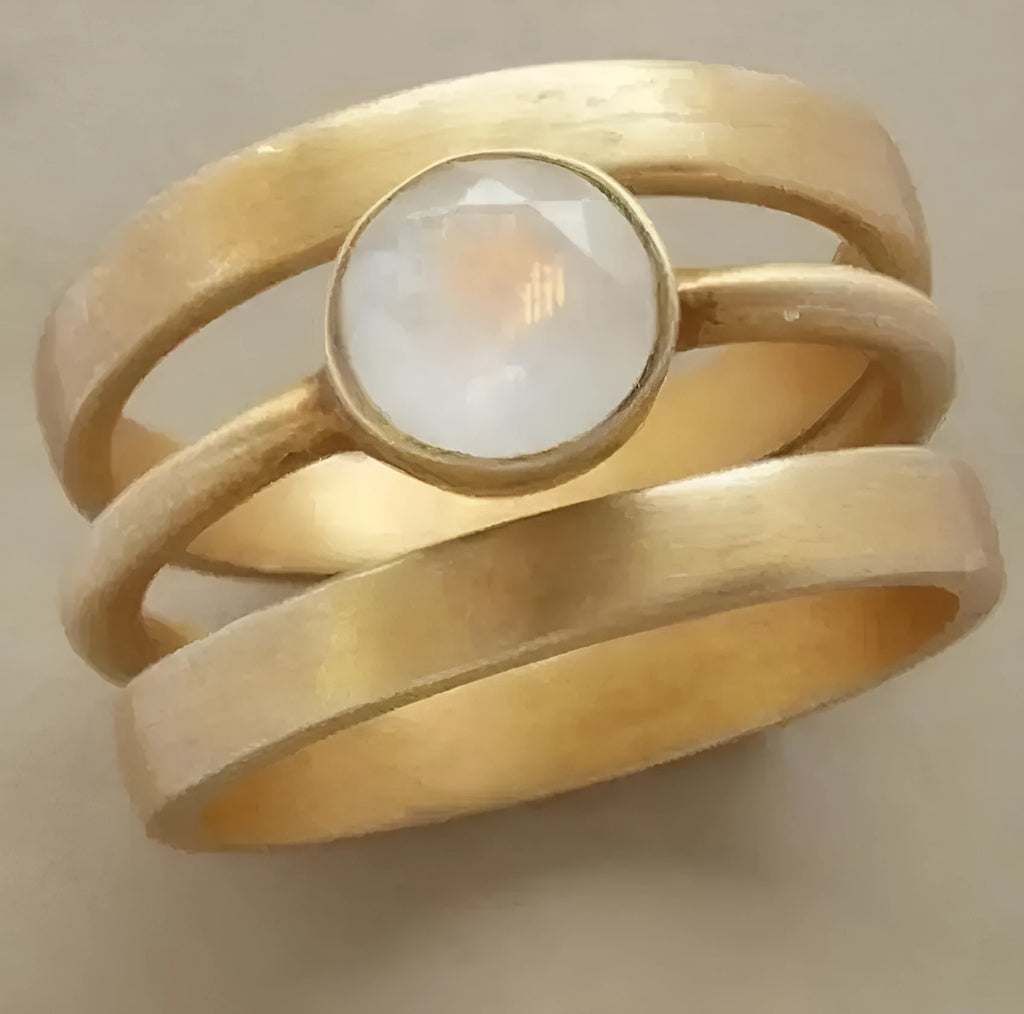 Gold titanium steel ring with hollow geometric design and micro-inlaid white chalcedony stone