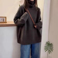Women's loose fit red turtleneck sweater with a thick 3D curling pile collar on a neutral background.