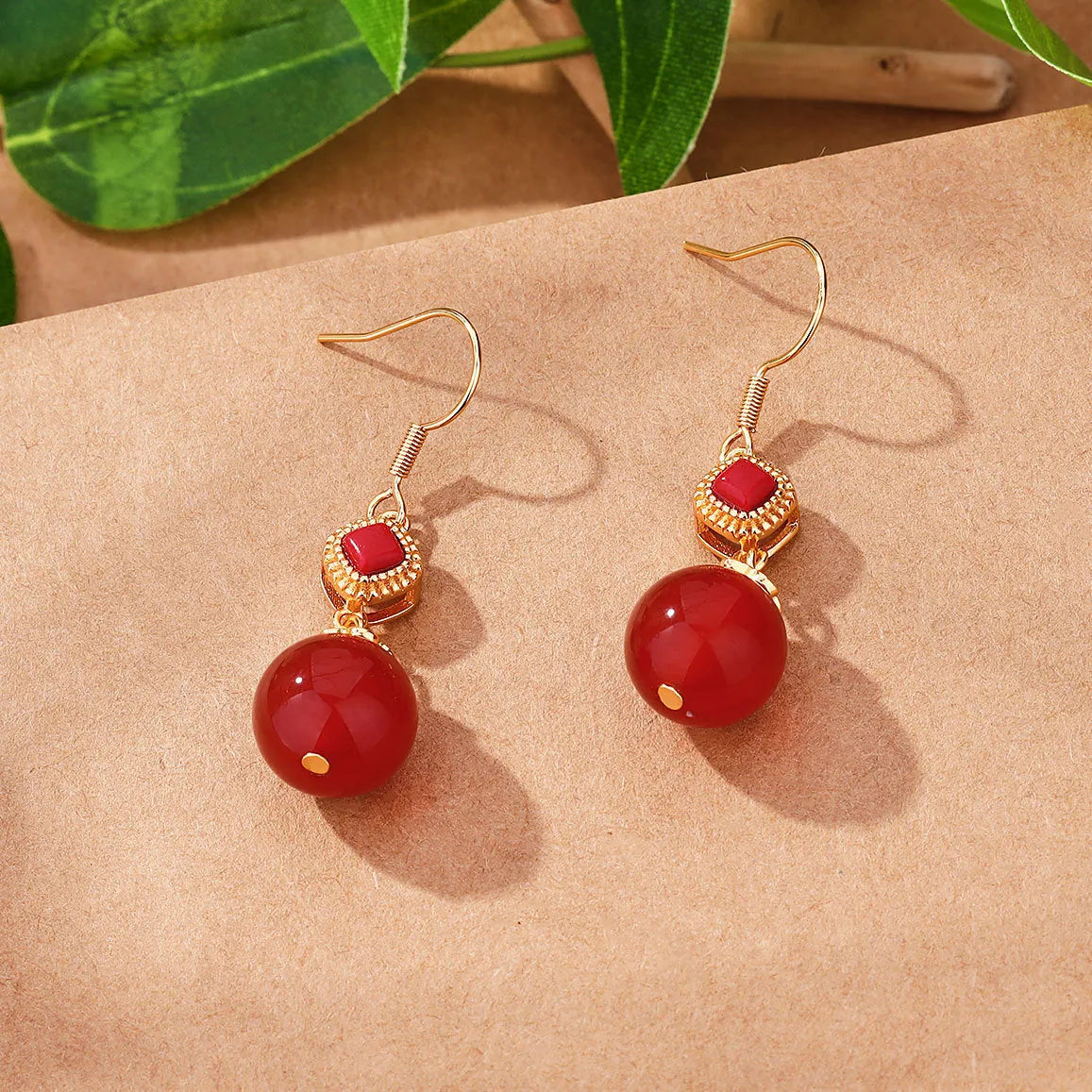 Geometric southern red agate and silver-inlaid jasper earrings with copper alloy posts.