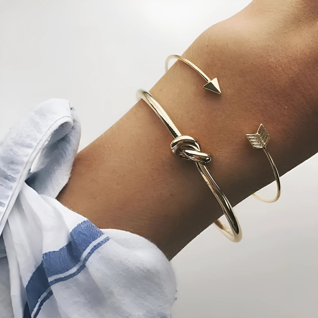 Gold vintage cuff bracelet for women with an arrow knot design detail.