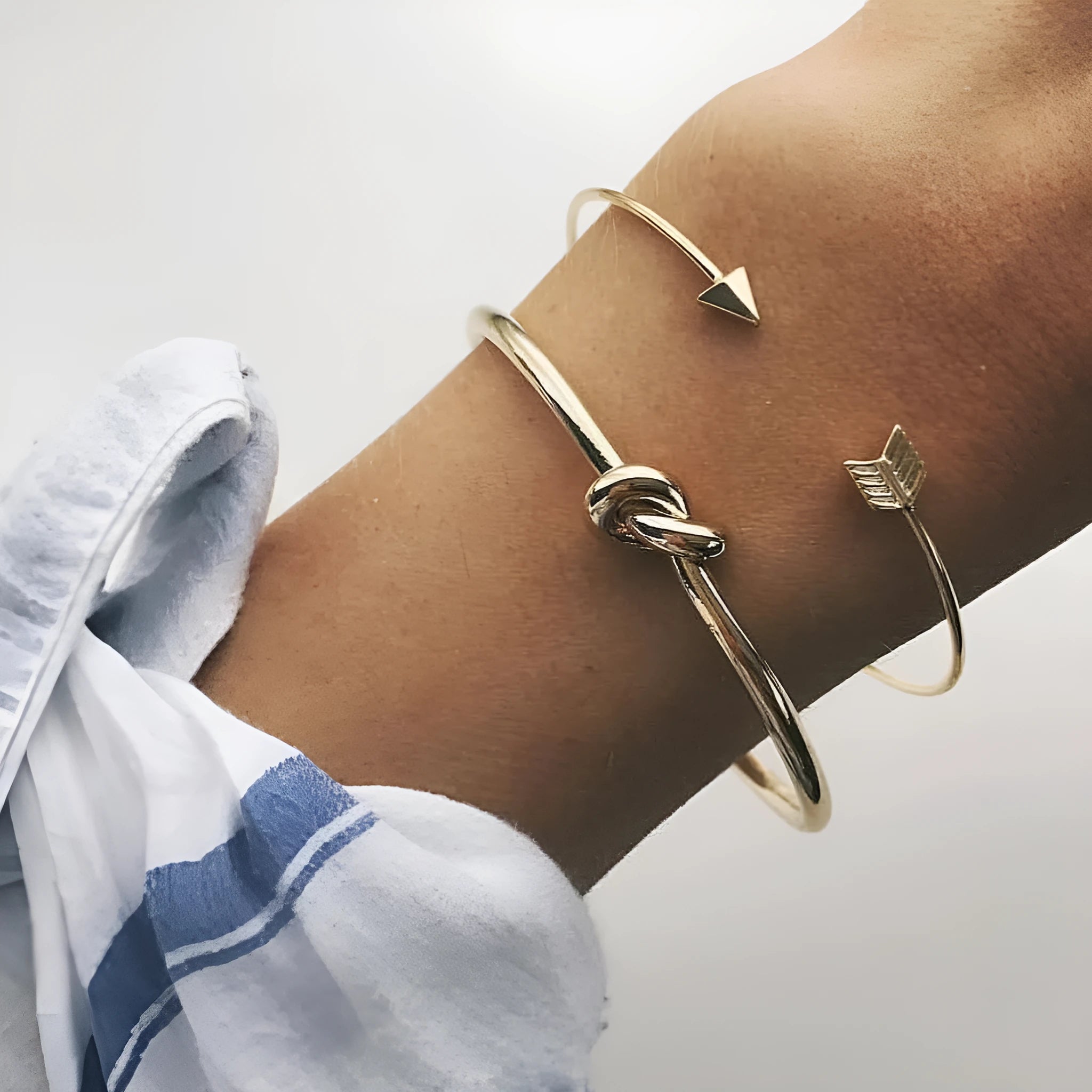 Gold vintage cuff bracelet for women with an arrow knot design detail.