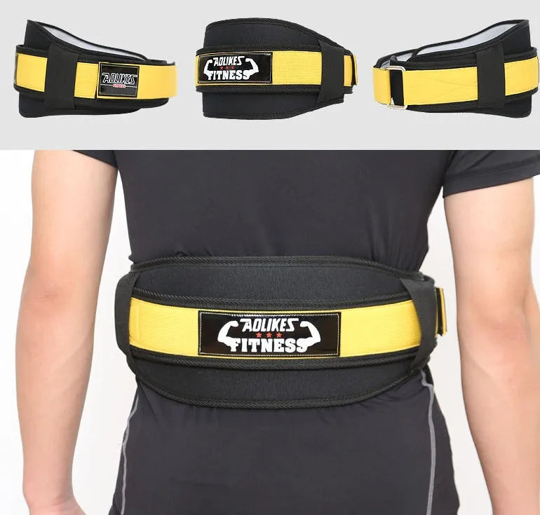 Black nylon fitness weightlifting belt on a gym floor, showing adjustable buckle and supportive width.