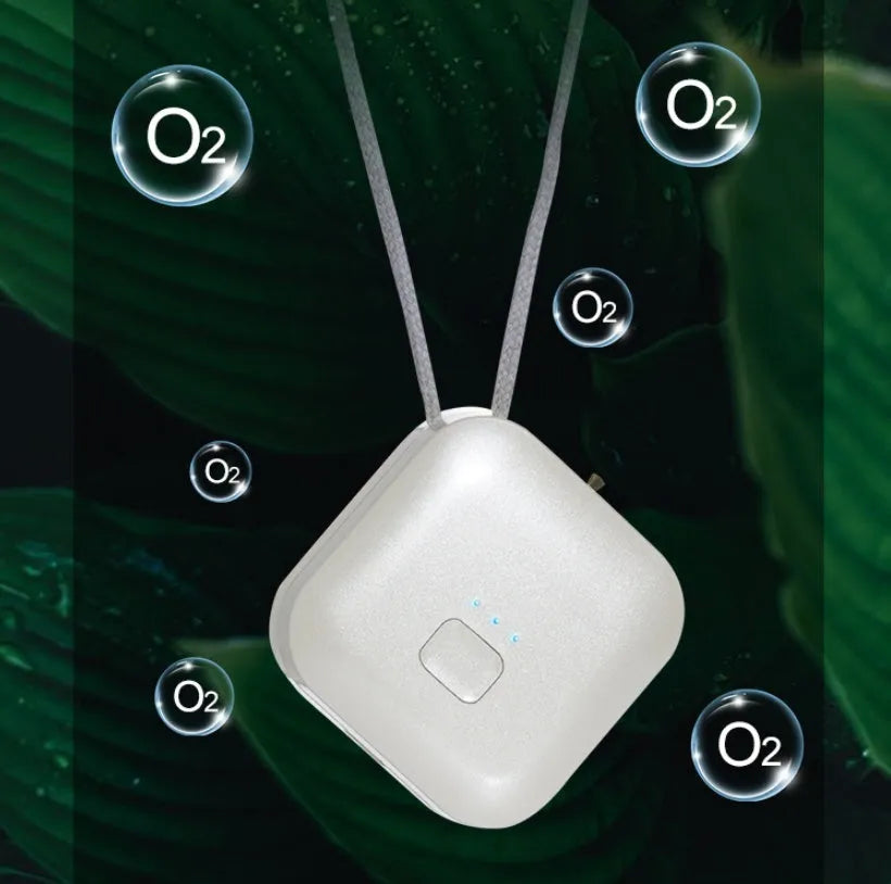 Mini USB portable air purifier necklace in pink, showing compact design with single button.