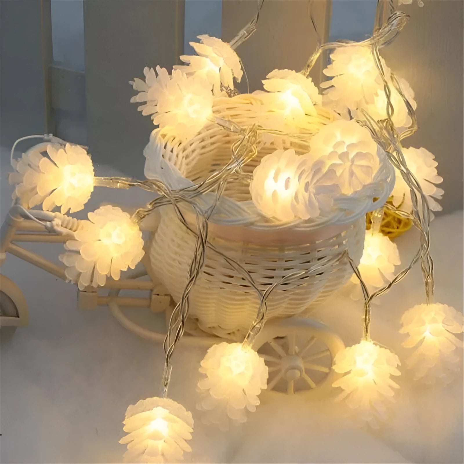 Battery powered LED pine cone light string in warm white colour with plastic shell construction