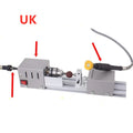 Silver metal mini woodworking lathe with carving tools on workbench