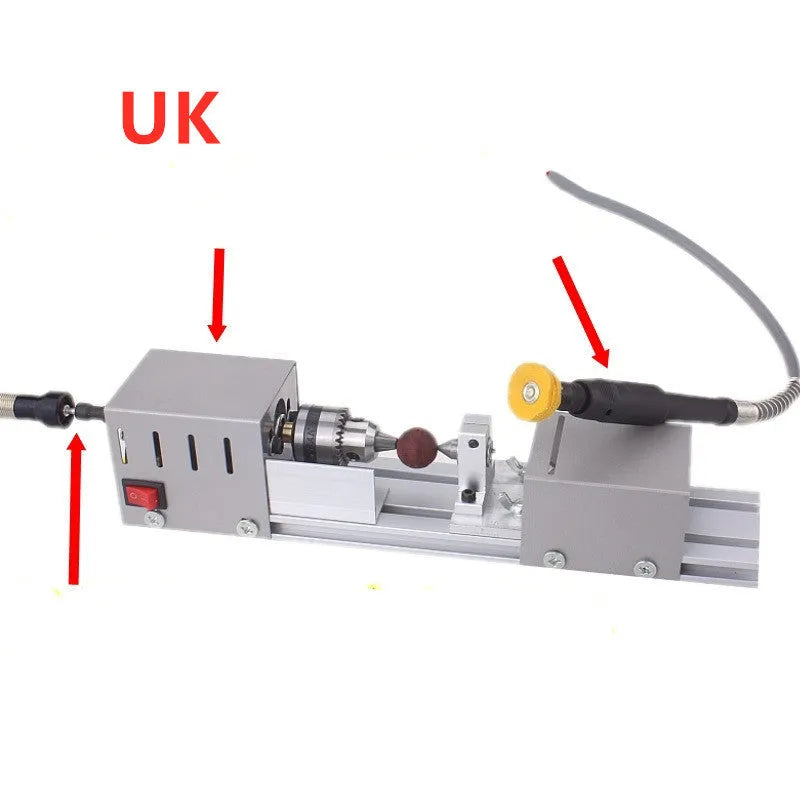 Silver metal mini woodworking lathe with carving tools on workbench