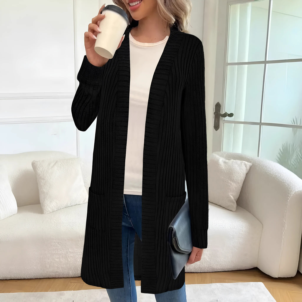 Long sleeve loose pocket knitted cardigan jacket in grey on a hanger.