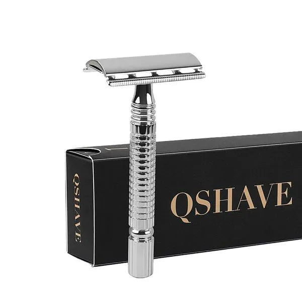 Double edged safety razor with chrome-plated brass handle and closed comb head on a storage box.