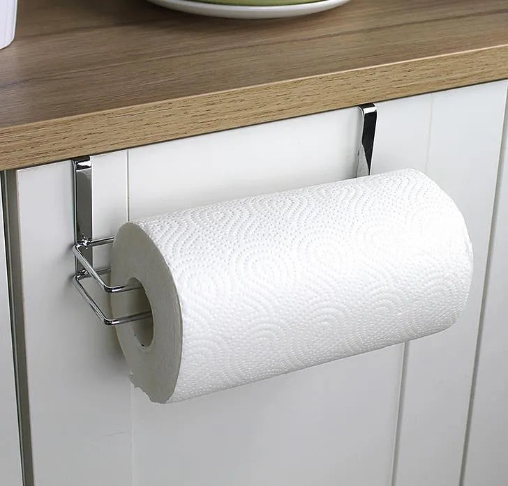 Silver stainless steel wire towel rack hanging on a kitchen cabinet door.