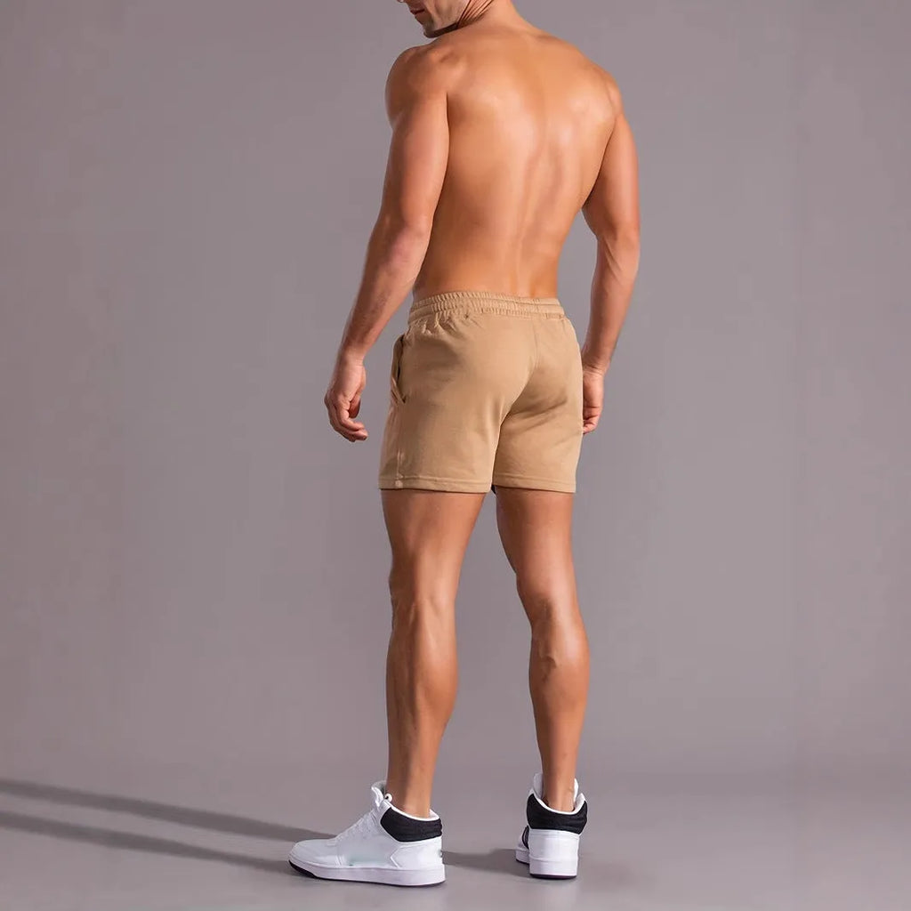 Men's khaki sports shorts with a coconut leaf pattern, showing a straight-leg fit and elasticated waistband.