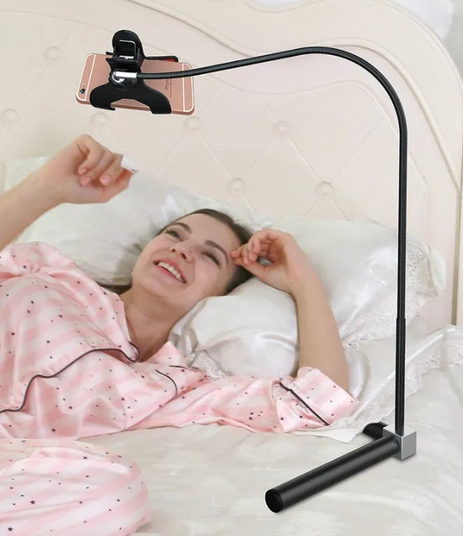 Black mobile phone bracket with universal folder attached to bed frame for hands-free viewing