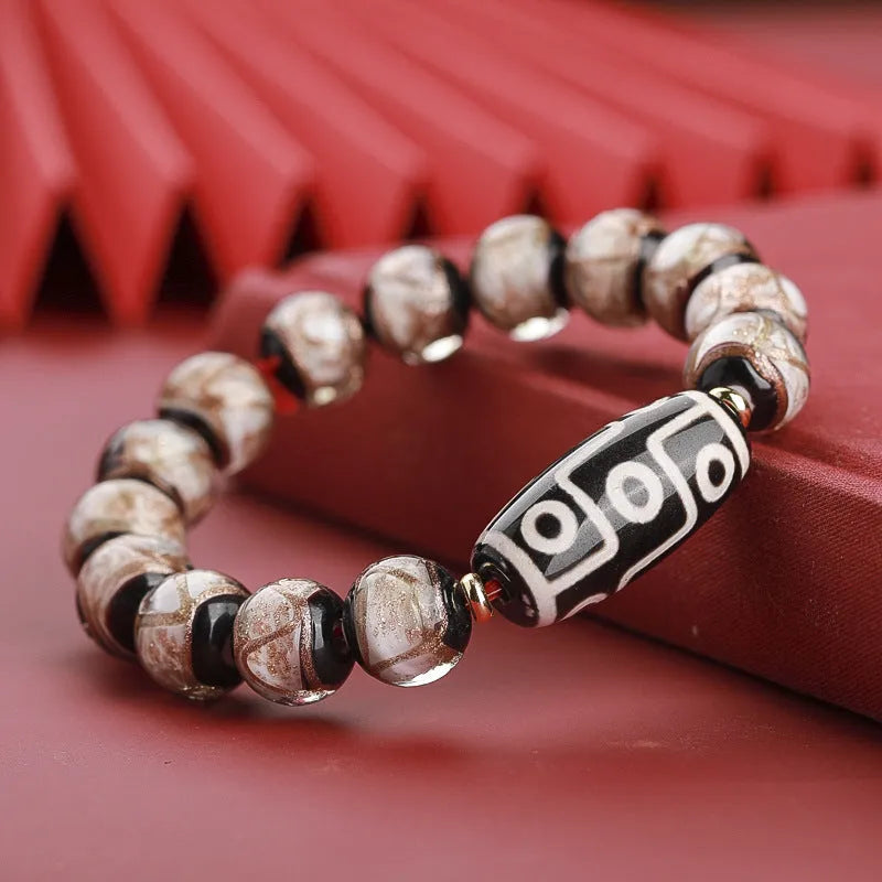 Close-up of a colourful handcrafted Chinese bracelet with snake lucky beads and auspicious patterns.