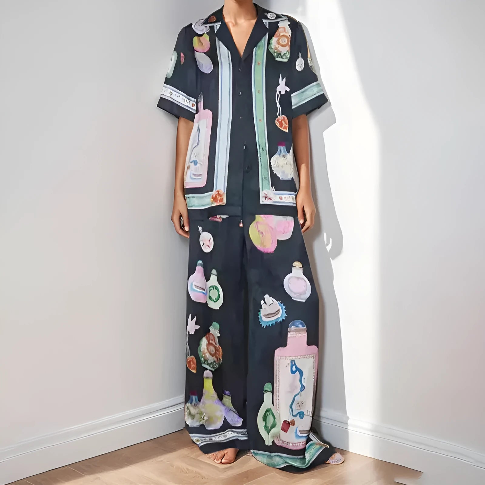 Black women's sleeve cardigan and trousers matching set with cartoon animation pattern.