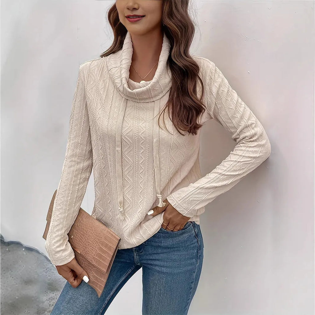 Apricot coloured long sleeve hooded pullover sweater on a hanger