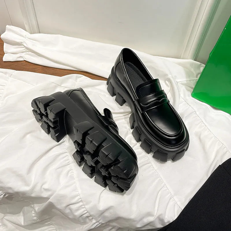 British style wide fat foot loafers in patent leather with a rubber sole.