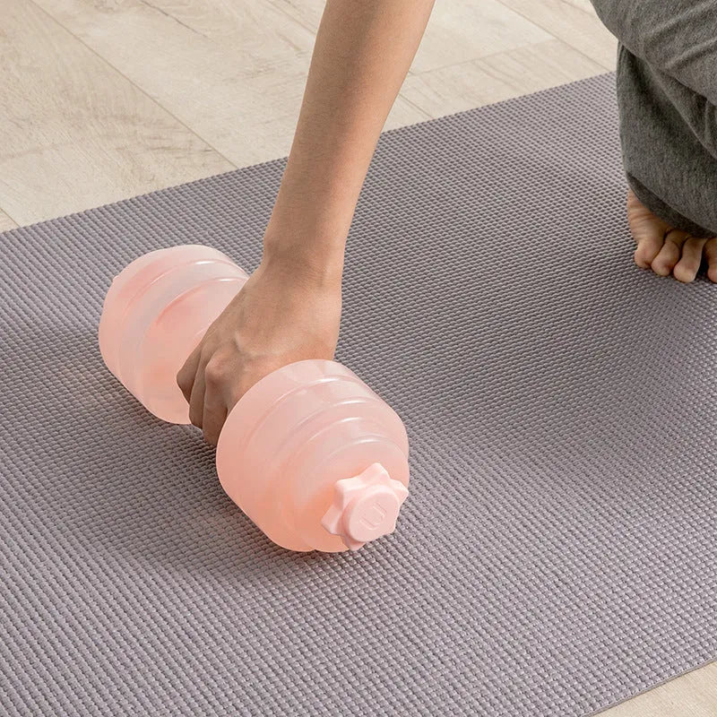 Mini portable plastic water dumbbell in transparent pink with water fill, PE construction, 262x97x94cm size for home strength training.