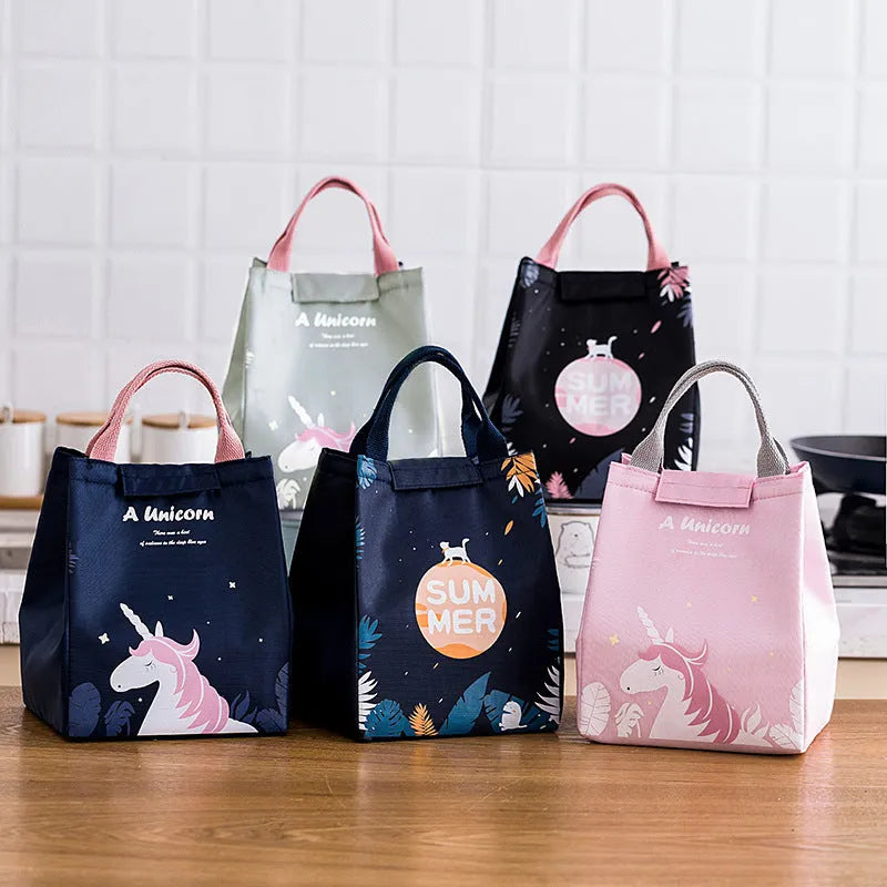 Insulated lunch bag with thermal lining showing character designs including grey unicorn and navy blue planet cat patterns