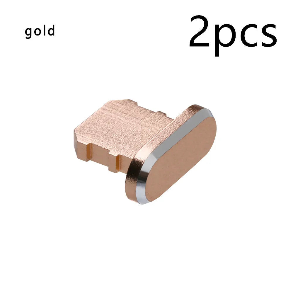Aluminium alloy iPhone charging port dust plug in metallic colours on a dark background.