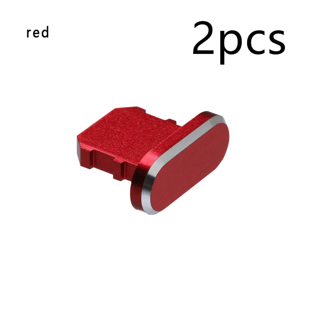 Aluminium alloy iPhone charging port dust plug in metallic colours on a dark background.