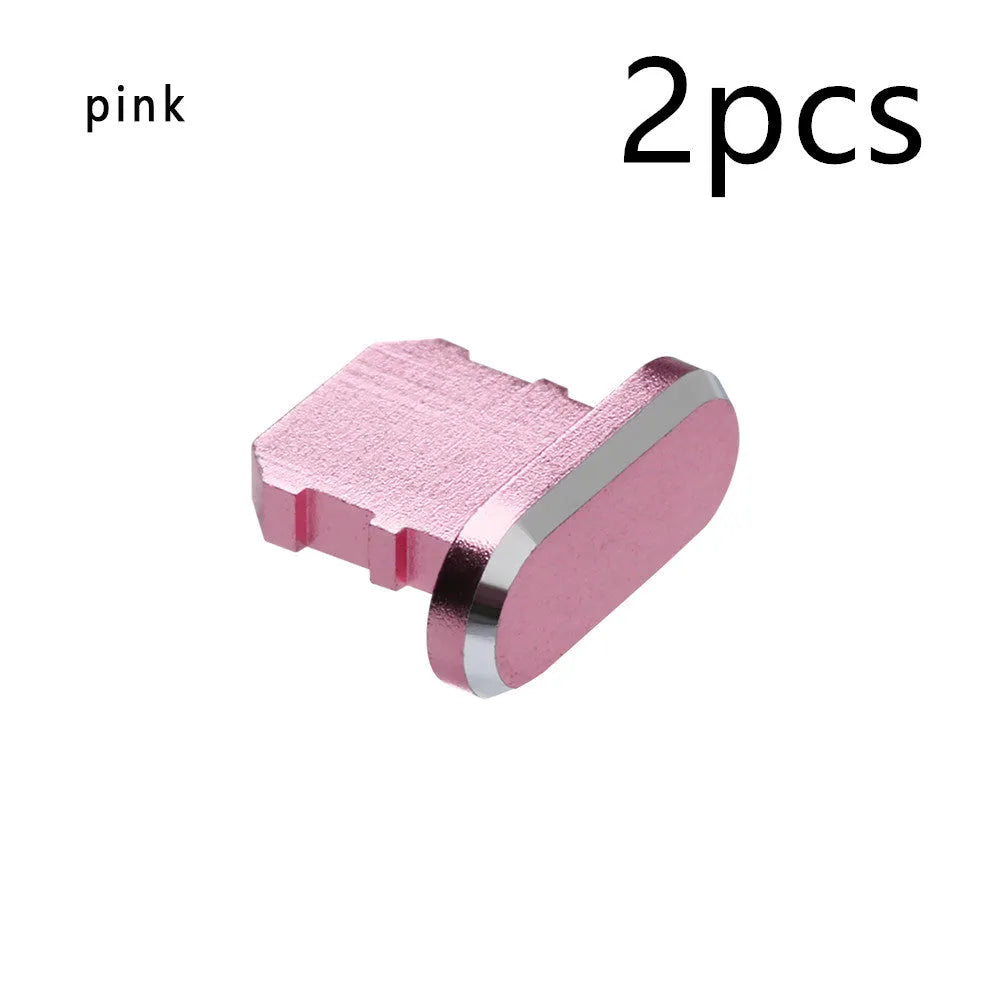 Aluminium alloy iPhone charging port dust plug in metallic colours on a dark background.