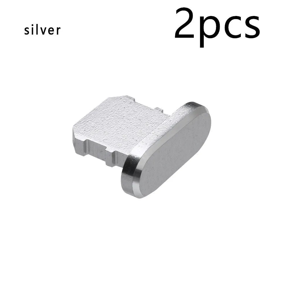 Aluminium alloy iPhone charging port dust plug in metallic colours on a dark background.
