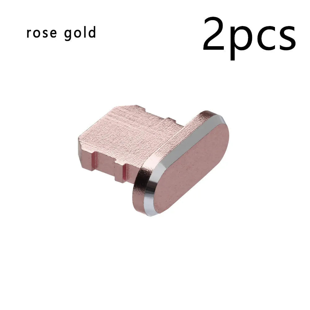 Aluminium alloy iPhone charging port dust plug in metallic colours on a dark background.