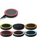 Qi wireless charging pad for mobile phones in six colour options on a wooden surface