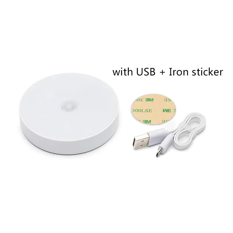 Small round motion sensing night light with USB charging port and adhesive backing