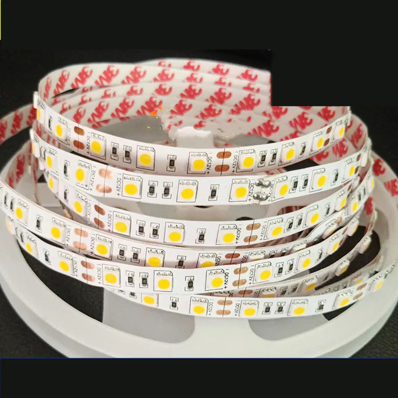 Close-up of a flexible white LED light strip with dense SMD LEDs, shown coiled, for shelf and counter lighting.