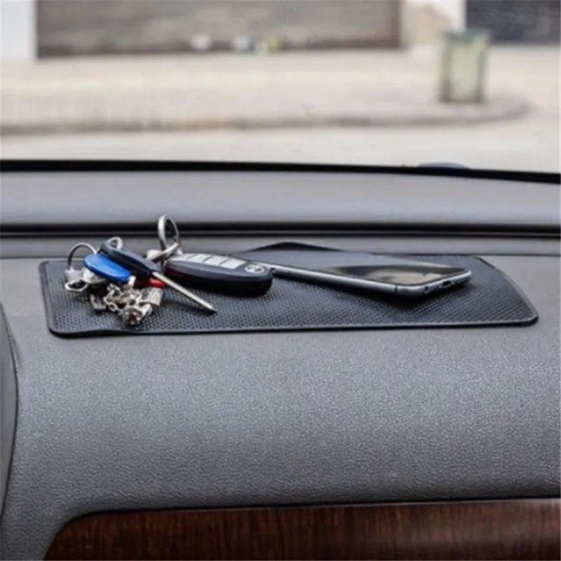 Black small mesh non-slip mat 18x13cm on car dashboard holding mobile phone and coins
